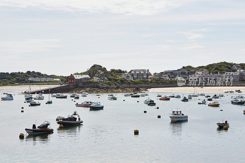 Isles of Scilly, United Kingdom - overview of harbor of St. MaryÂ´s with many boats anchoring and town and lifeboat station in the background